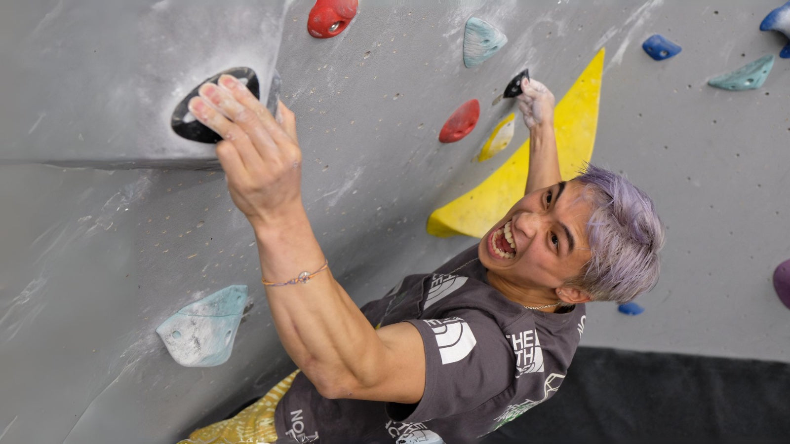 Jonathan Sin on an indoor climbing wall
